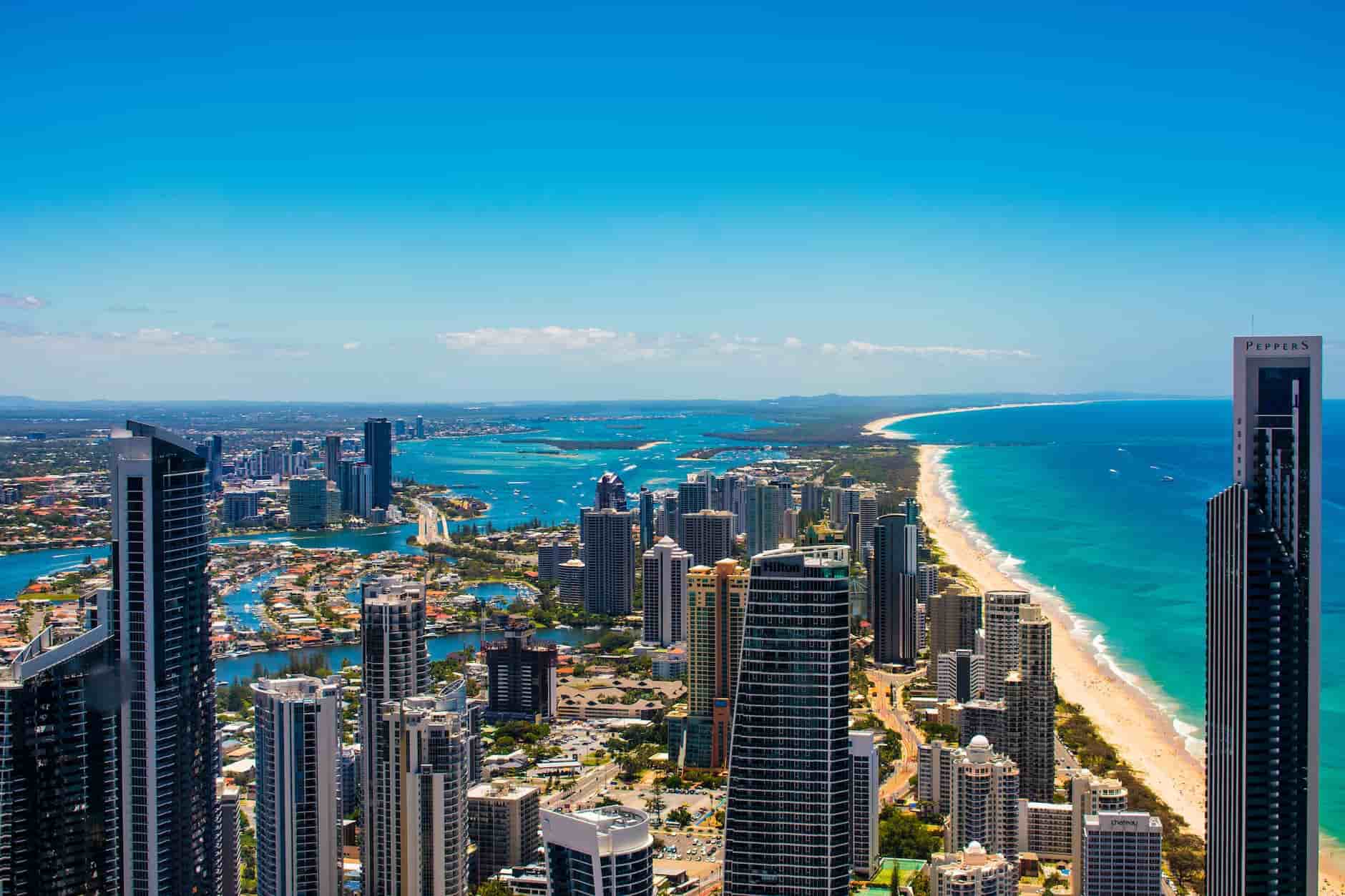 Finances skyscrapers over a city near the beach Goldcoast Australia sunny blue sea bright and sunny